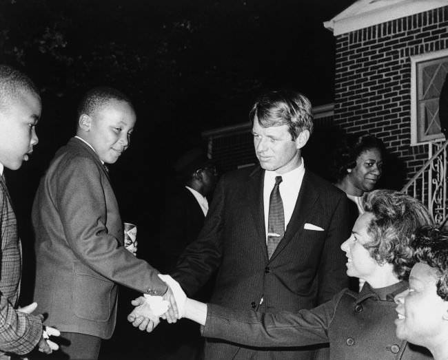 Ethel Kennedy shakes hands with Martin Luther King III after she and Robert F. Kennedy visited Coretta Scott King at her Atlanta home, 1968.