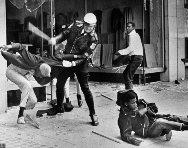 A police officer uses his nightstick on a youth in Memphis, Tennessee, 1968.