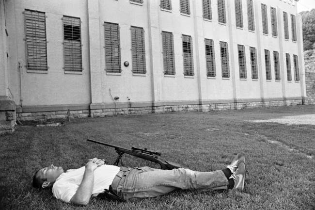 An unidentified sharpshooter at Brushy Mountain State Prison at Petros, Tennessee, takes a nap on the lawn in front of Cellblock after duty in the search for six escaped convicts, 1977.