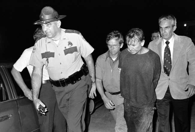 James Earl Ray, right, is escorted by Brushy Mountain State Prison Warden Stonney Lane following his capture in the rugged country near Petros, Tennessee, 1977.