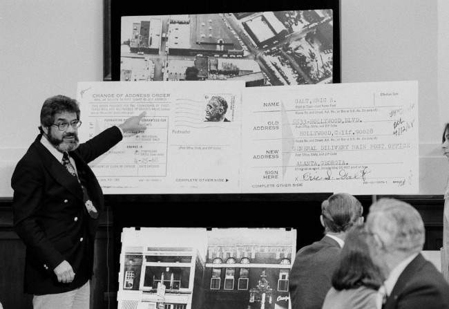 Mark Lane, attorney for James Earl Ray, stands by an enlarged change of address form during the session of the House Assassinations Committee in Washington, 1978.