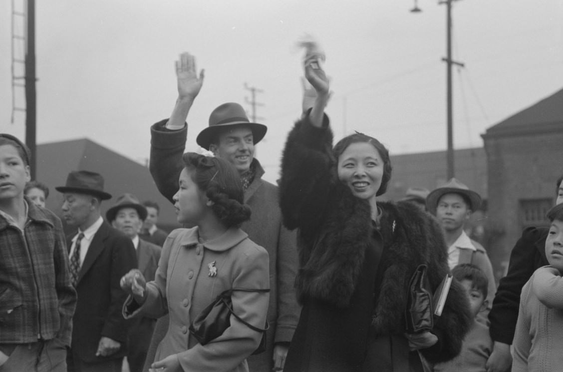 Waving good-bye to friends and relatives who are leaving for Owens Valley, 1942.