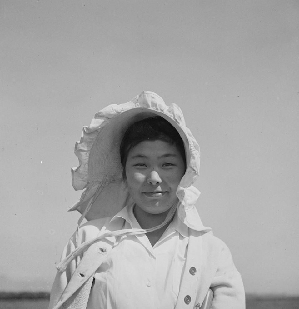 San Benito County, California. Japanese-American working in a field while awaiting final evacuation orders, 1942.