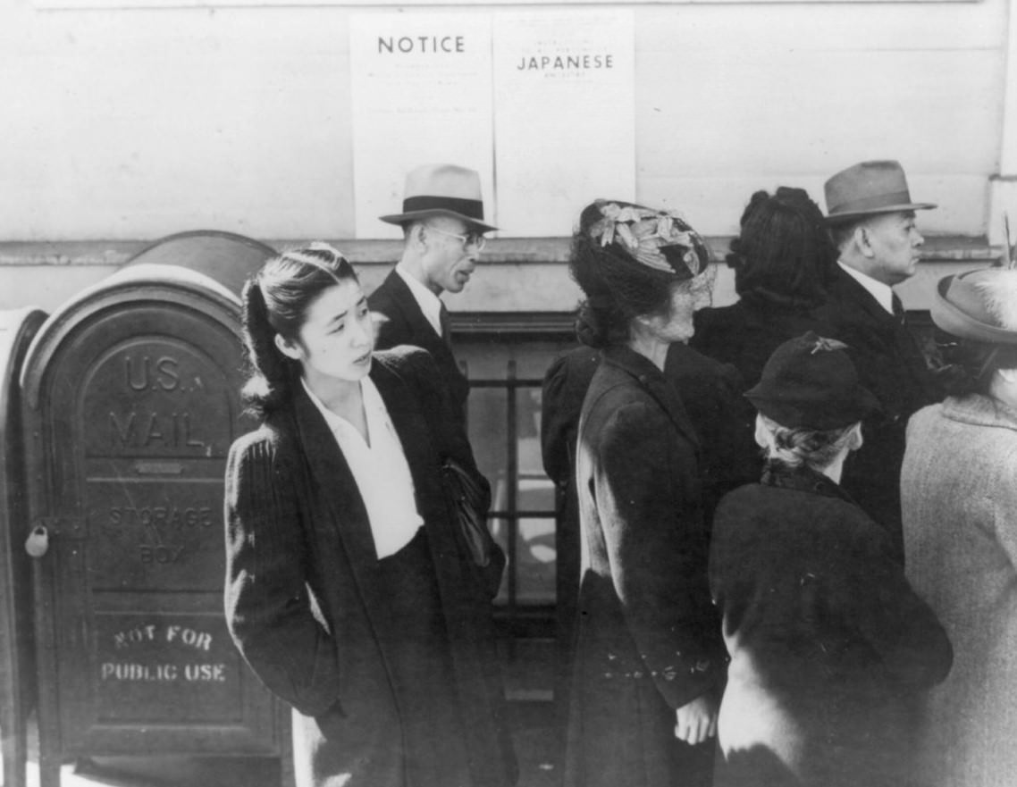 Shizuko Ina standing behind unidentified Japanese Americans, San Francisco, 1942.