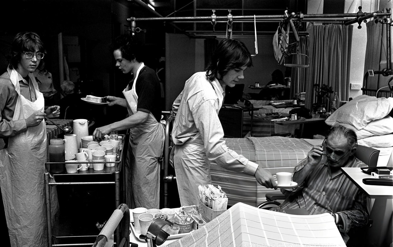 Pupils from Westminster City School, London help to serve food and drinks to patients at London's Westminster Hospital, 1972.