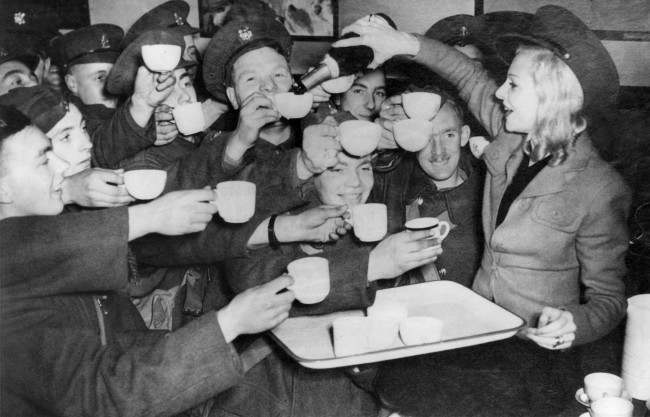 Miss Claire Luce, right, well known British Actress, served champagne to the British Tommies who flocked into the canteen she opened under the name of St. Peter's kitchen at St. Pancras station in London on Nov. 7, 1939.