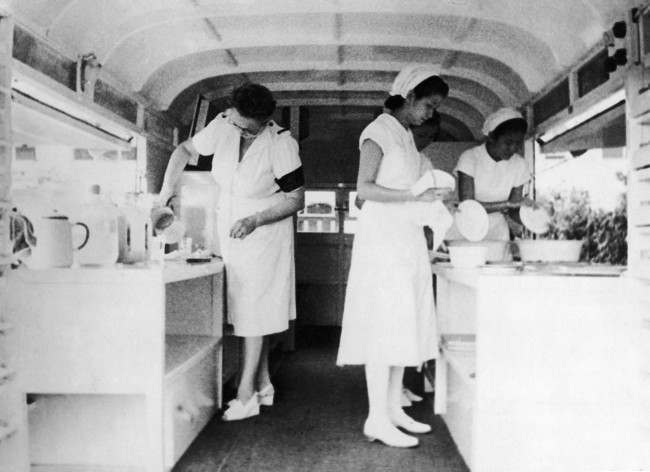 European and Chinese canteen girls serving in a mobile canteen given by a civilian to the Singapore Passive Defense Services in, Jan. 31, 1942.