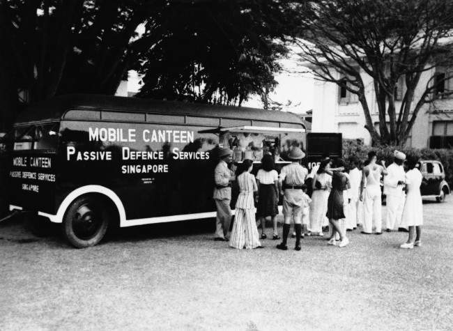 This mobile canteen carries food and refreshments throughout Singapore now under fierce Japanese attack shown Feb. 11, 1942. It is operated by European and Chinese girls as part of the passive defense services there.