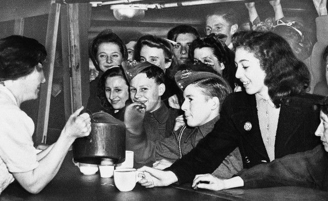 Young Londoners, in a shelter against Hitler's robot bombs, crowd the canteen for refreshments, deep under the city of London, July 25, 1944. When completed, the shelters will provide sleeping accommodations for 40,000 persons.