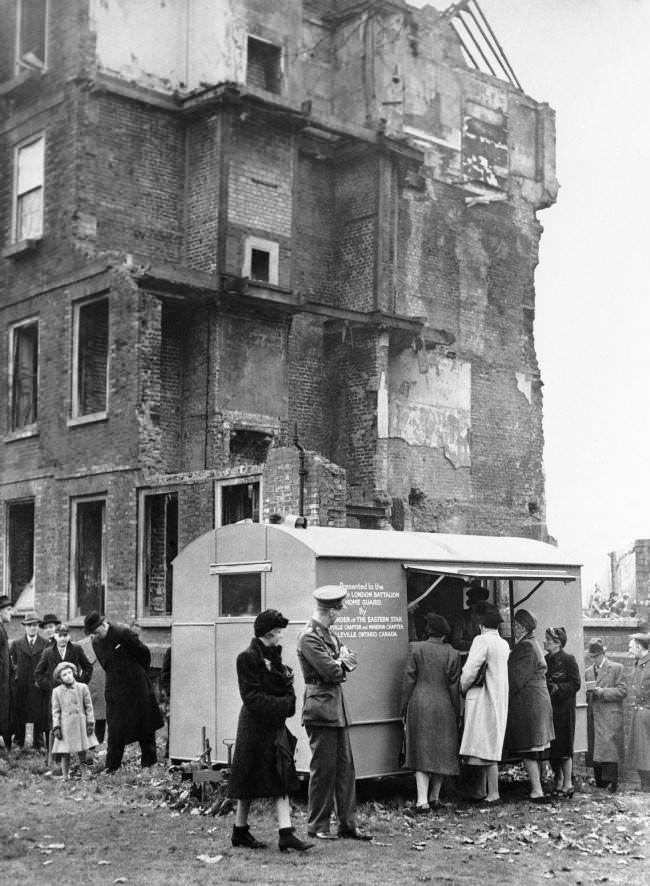 A canteen presented by the people of Canada to the London home guard is set up alongside a bomb-shattered building in London on Dec. 28, 1942.