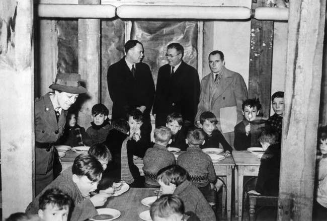 The delegates visit a canteen in a Brussels school in Belgium on Jan 28, 1941. From left to right are: Mr. G. Murray, Mr. Mac Donald, and Mr. Frederic Dorsey Stephens, Head of the delegation.