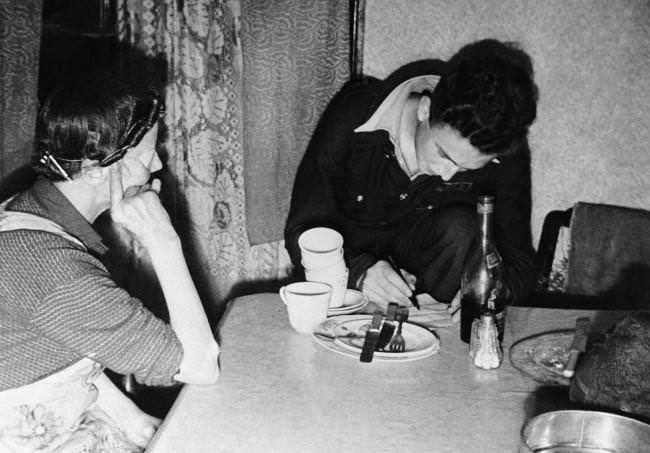 Christopher Ounsted, driver of the mobile canteen, takes the order for a days meal from a woman who is partly blind in London on Sept. 17, 1941.