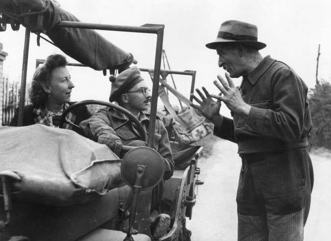 An Army Medical officer acts as a village doctor to the civilians of Benouville, Normandy. A dispenser from a local hospital travels around with the officer and acts as his interpreter. The treatment and advice given by the officer is much appreciated by the people of Benouville, they have had no doctor to consult since D-Day. The people not only seek treatment for themselves, but they bring their animals along too. The Medical Officer from South Africa goes on rounds in his jeep in France, 1944.