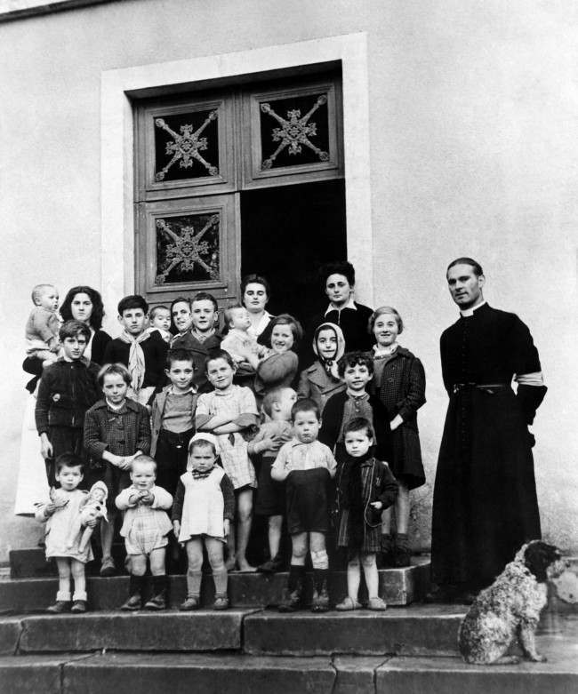 French war orphans with Abbe Noe, Parish priest, at the new French colony opened by the Foster Parents plan for war children, 1944.