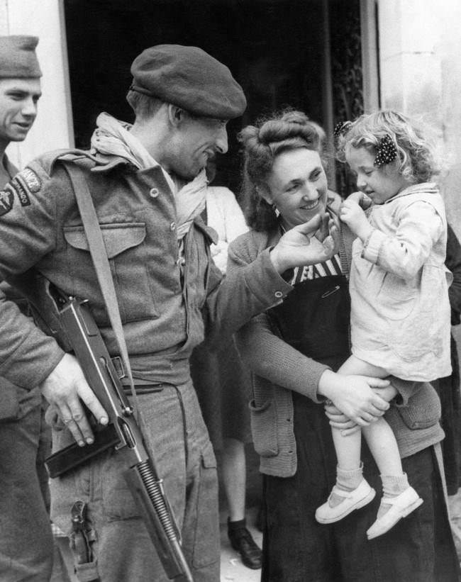 French villagers welcomed members of a French Commando who landed in Normandy in Amfreville, North of Ranville, 1944. Chester Wilmot, BBC commentator was also there at the time.