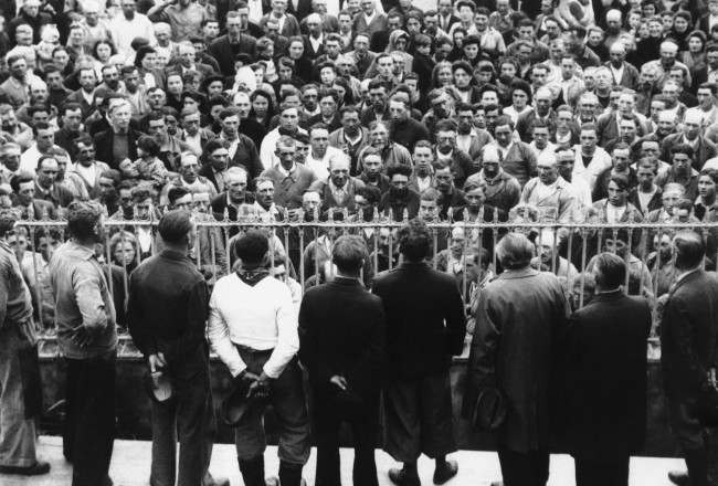 The men folk of the fishing village of Grandcamp Les Bains in Normandy, France, are being addressed by members of the resistance committee to voluntarily register for the new army of France, 1944.