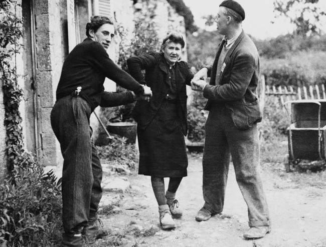 Two French patriots dragged Grande Guillotte from her home in Normandy, France, 1944.