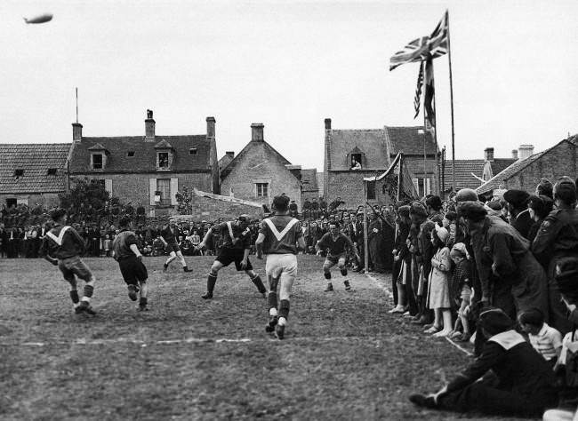 For the first time since 1939, French men and women in the liberated towns and villages of Normandy were able openly to celebrate on July 14th, Bastille Day, without fear of German reprisals. In the little town of Coursoulles near the coast, British troops played a football match against the local French team and all the towns folk turned out to watch the game, 1944.