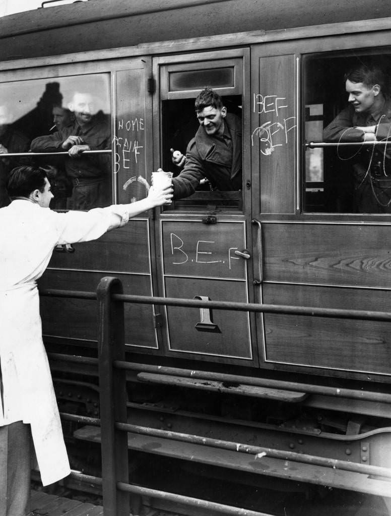 Voluntary helpers give refreshments to wounded soldiers, members of the British Expeditionary Force, on board a hospital train, 1940.