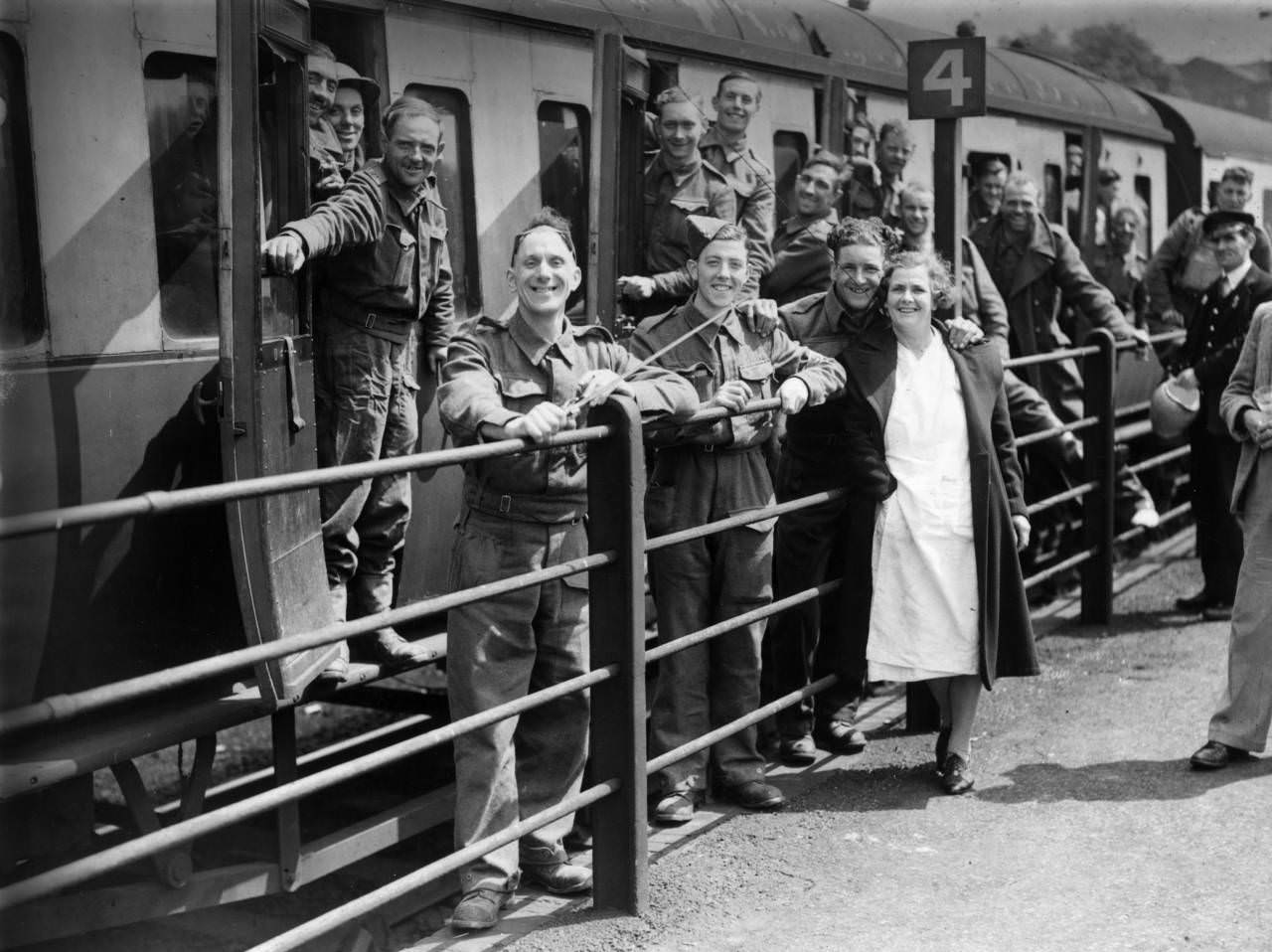 Members of the BEF (British Expeditionary Force) smiling happily at a halt in their journey as they arrive safely in England after escape from Dunkirk, 1940.