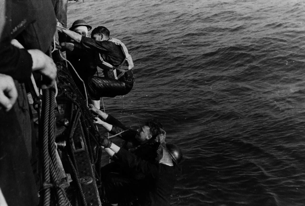 A British ship rescues soldiers from a landing craft sunk during an operation, 1940.