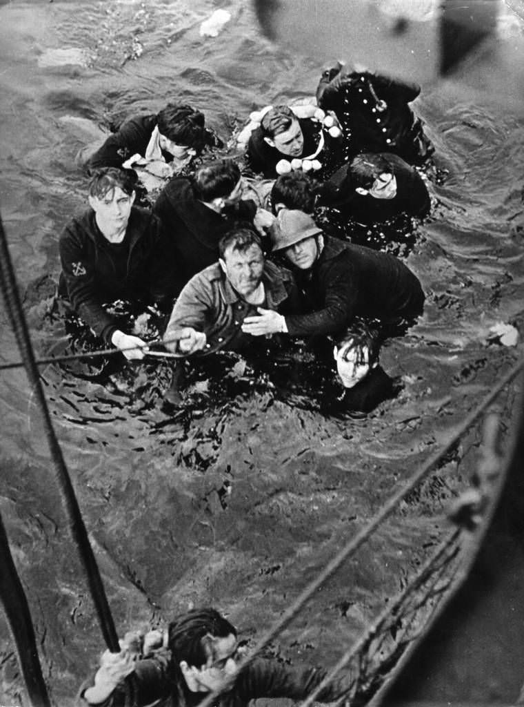 A British ship rescues soldiers from a landing craft sunk during an operation, 1940.