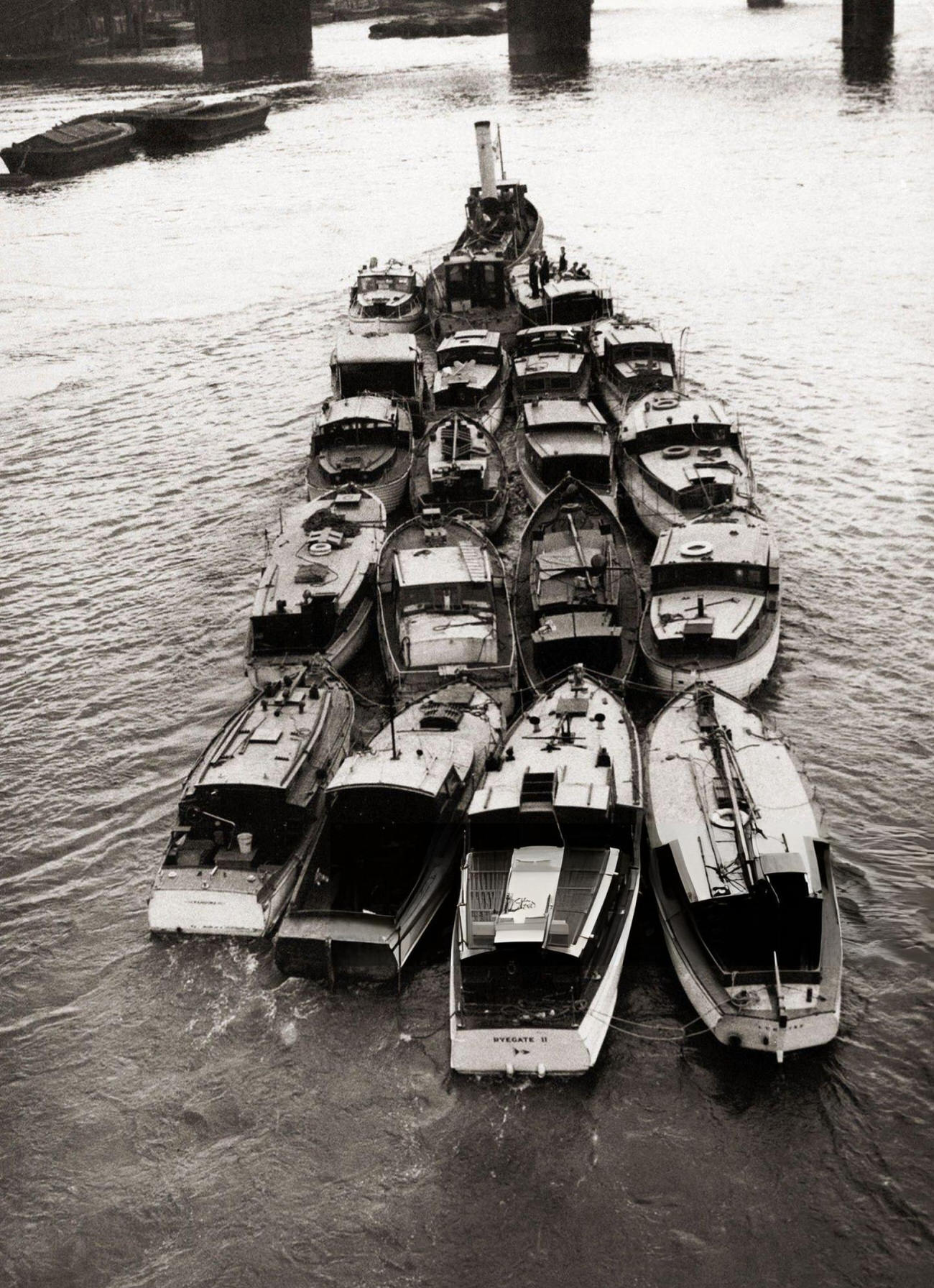 A flotilla of little boats helped in the evacuation of British, French, and Belgian troops from the beaches around the French channel port of Dunkirk. They are seen here being towed back up the river Thames, 1940.