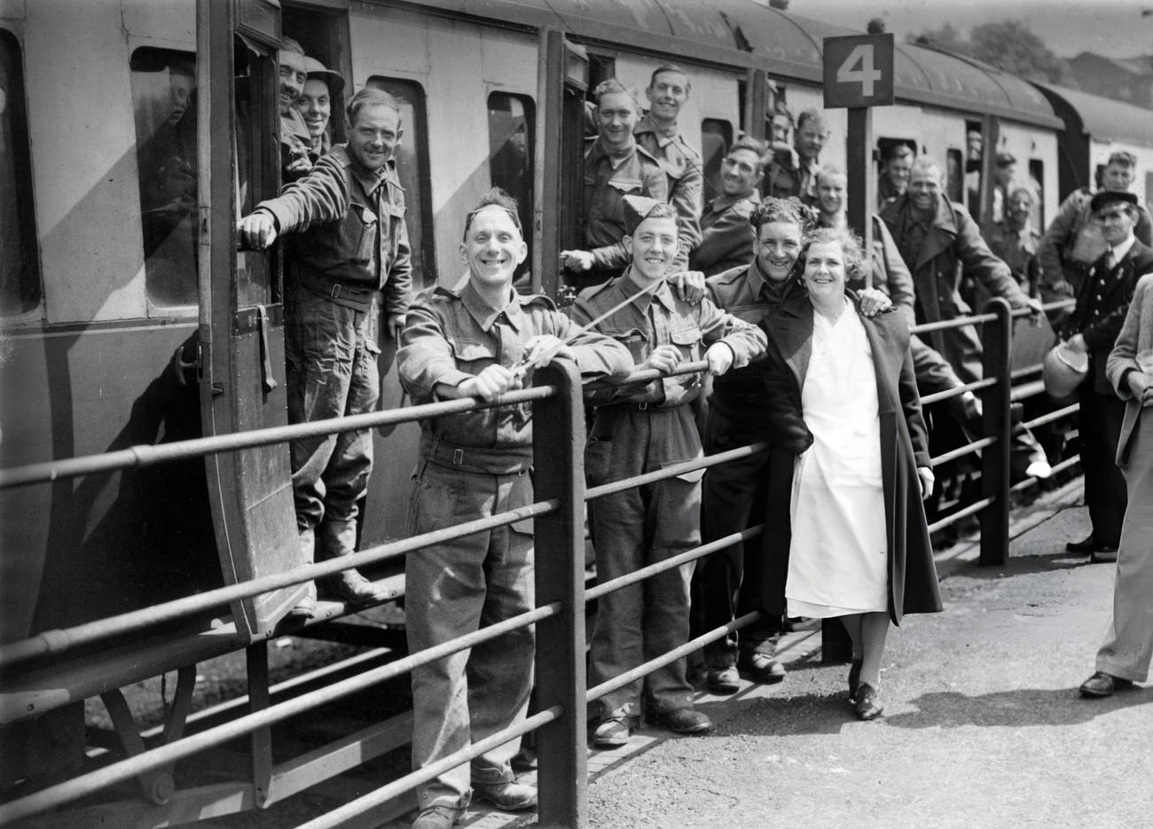 Members of the BEF (British Expeditionary Force) smiling happily at a halt in their journey as they arrive safely in England after escape from Dunkirk, 1940.