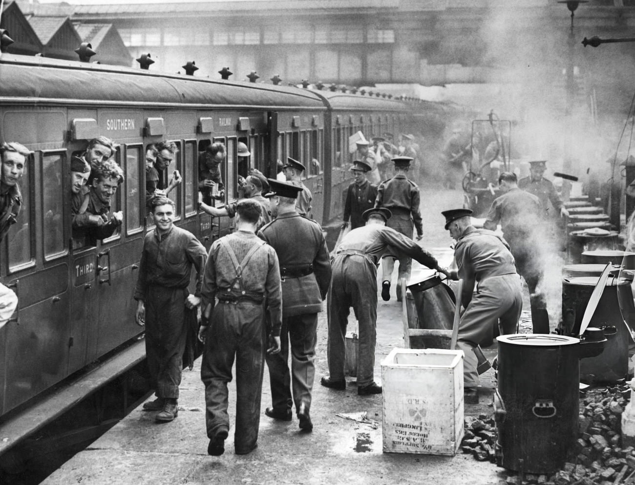 A cook house set up on a London station platform, England, serving hot food to servicemen arriving from northern France, following the evacuation of Allied troops from Dunkirk, 1940.