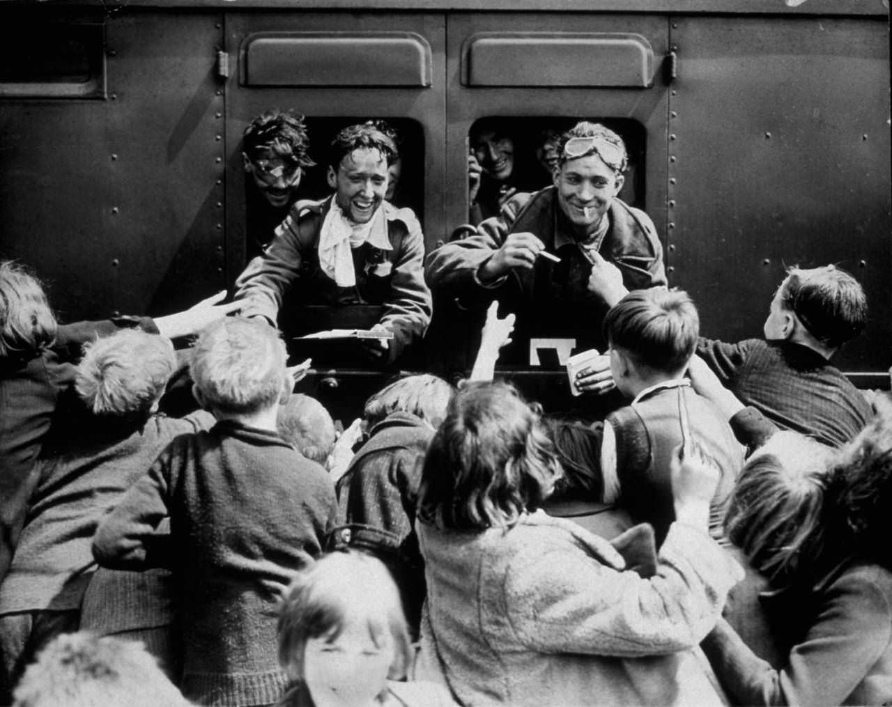 Children rush up to a train carrying BEF men back from Dunkirk, 1940.