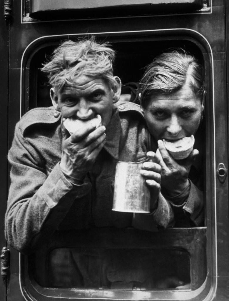 Two soldiers tuck in to the food and refreshment they received after their arrival in Britain, after evacuation from Dunkirk, 1940.