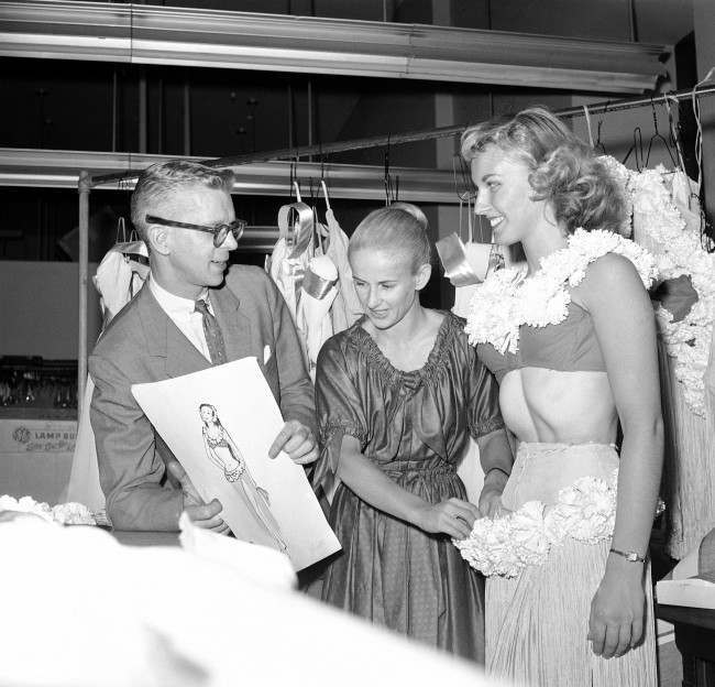 A hula costume is fitted on dancer Mary Ann Strilka, 1958.