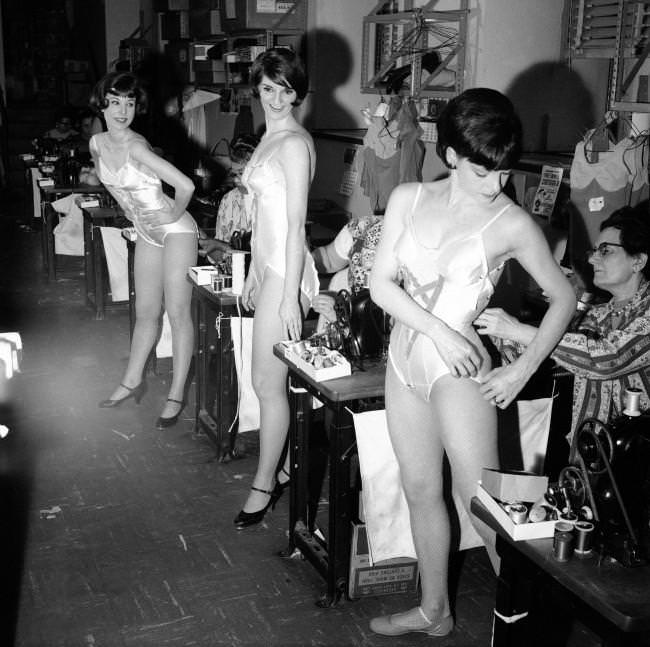 Louise Thompson, Judy Little, and Joyce Hector are fitted for costumes for a new show, 1966.