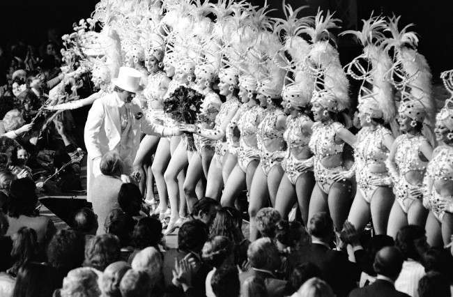 Flowers are handed out both from the audience and by top-hatted man to the Rockettes, 1978.