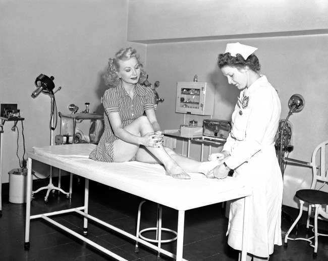 Olga Burke, one of the Radio City Music Hall Rockettes, has her ankle taken care of in the backstage hospital, 1946.