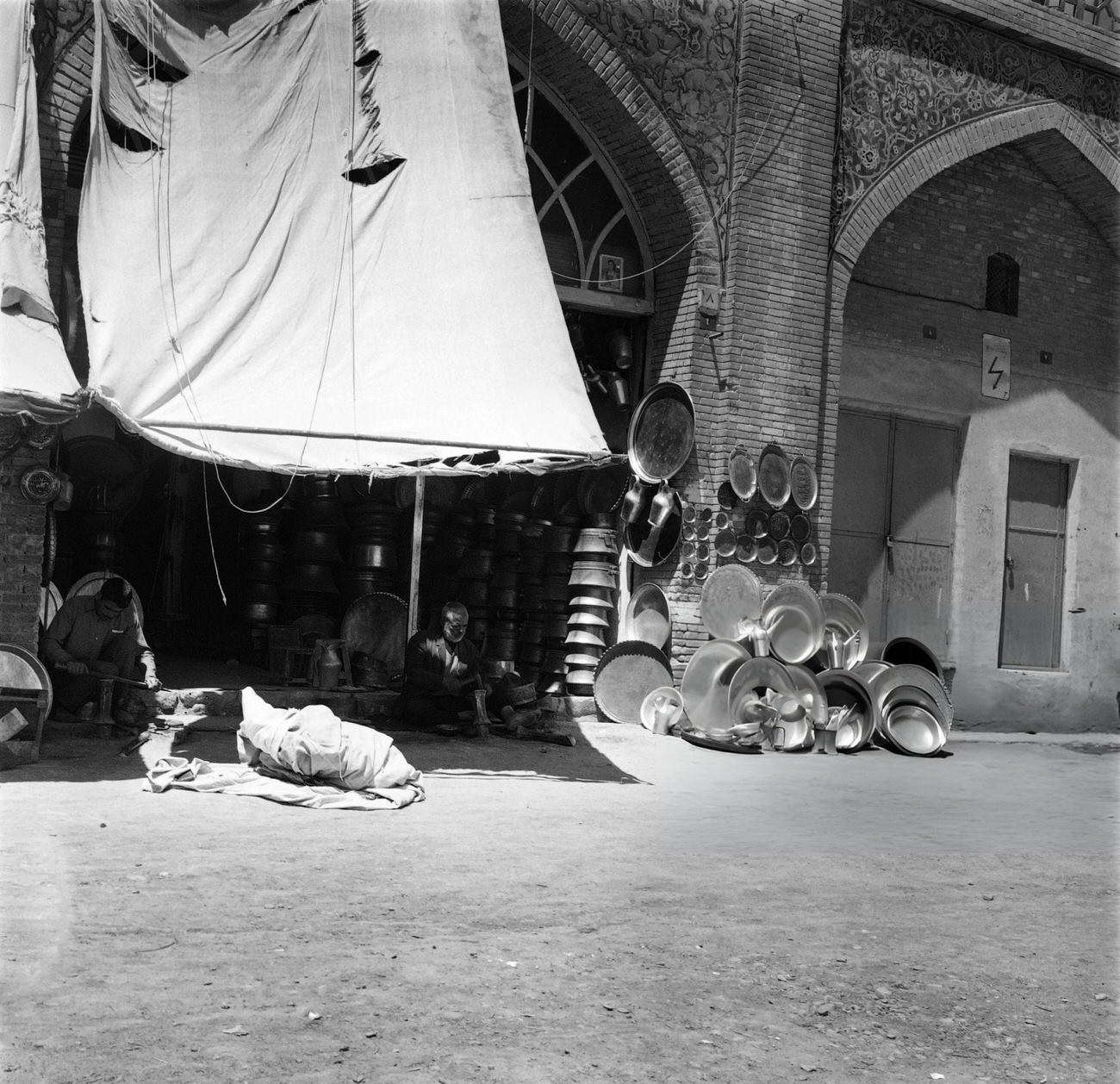 Iranian men seat outside their shop in Tehran, 1968.