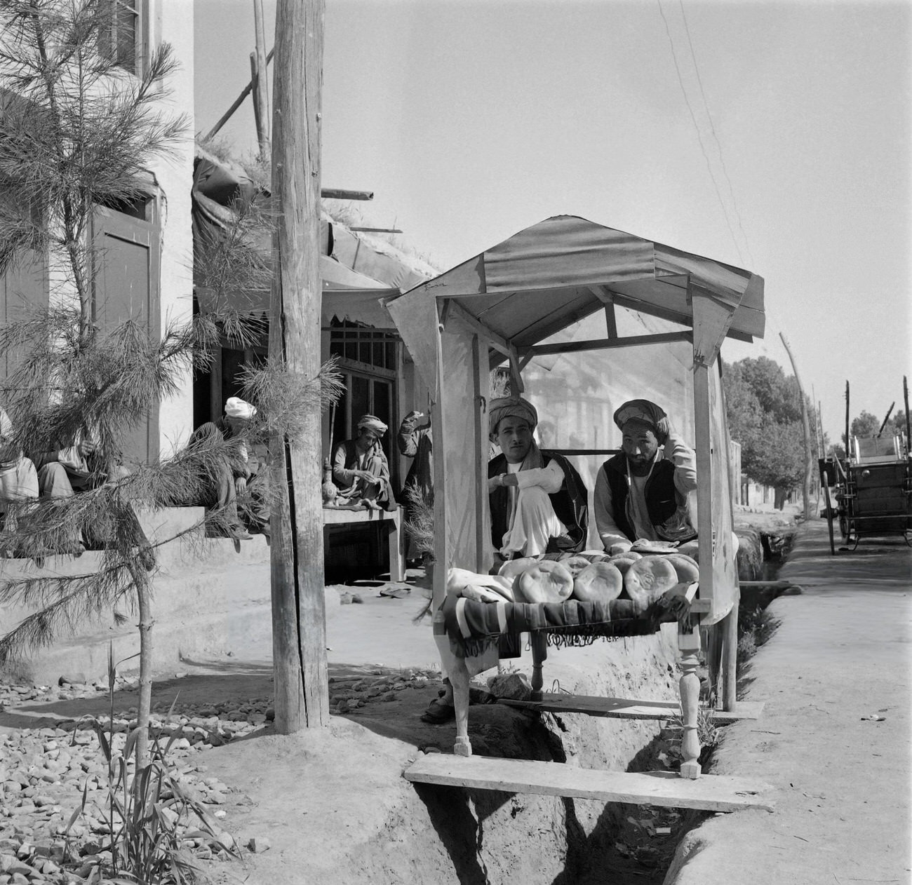 Iranian men sell bread in a street of Tehran, 1968.