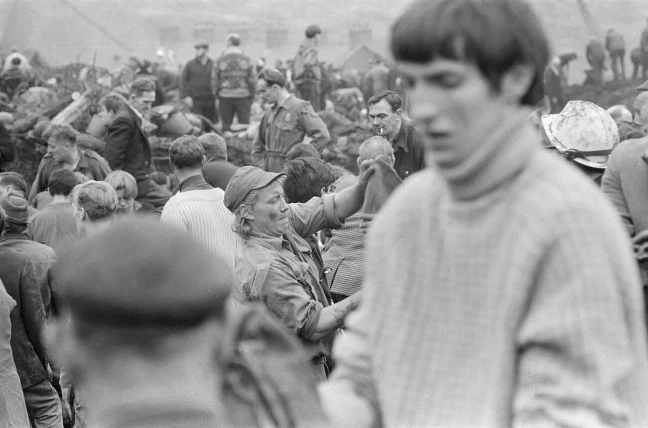 Local men and the emergency services hastily dig through the mud for survivors at the Pantglas Junior School, 1966.