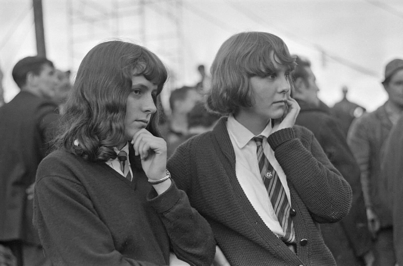 Two young school girls watch anxiously in bewilderment and disbelief as the rescue effort for survivors at the Pantglas Junior School frantically goes on, 1966.