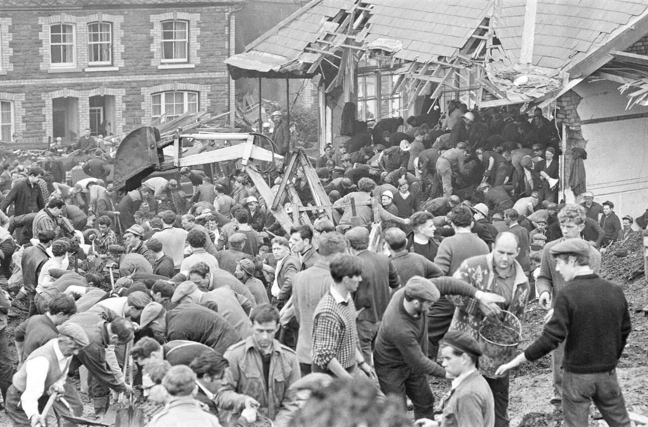 Local men and the emergency services hastily dig through the mud for survivors at the Pantglas Junior School, 1966.