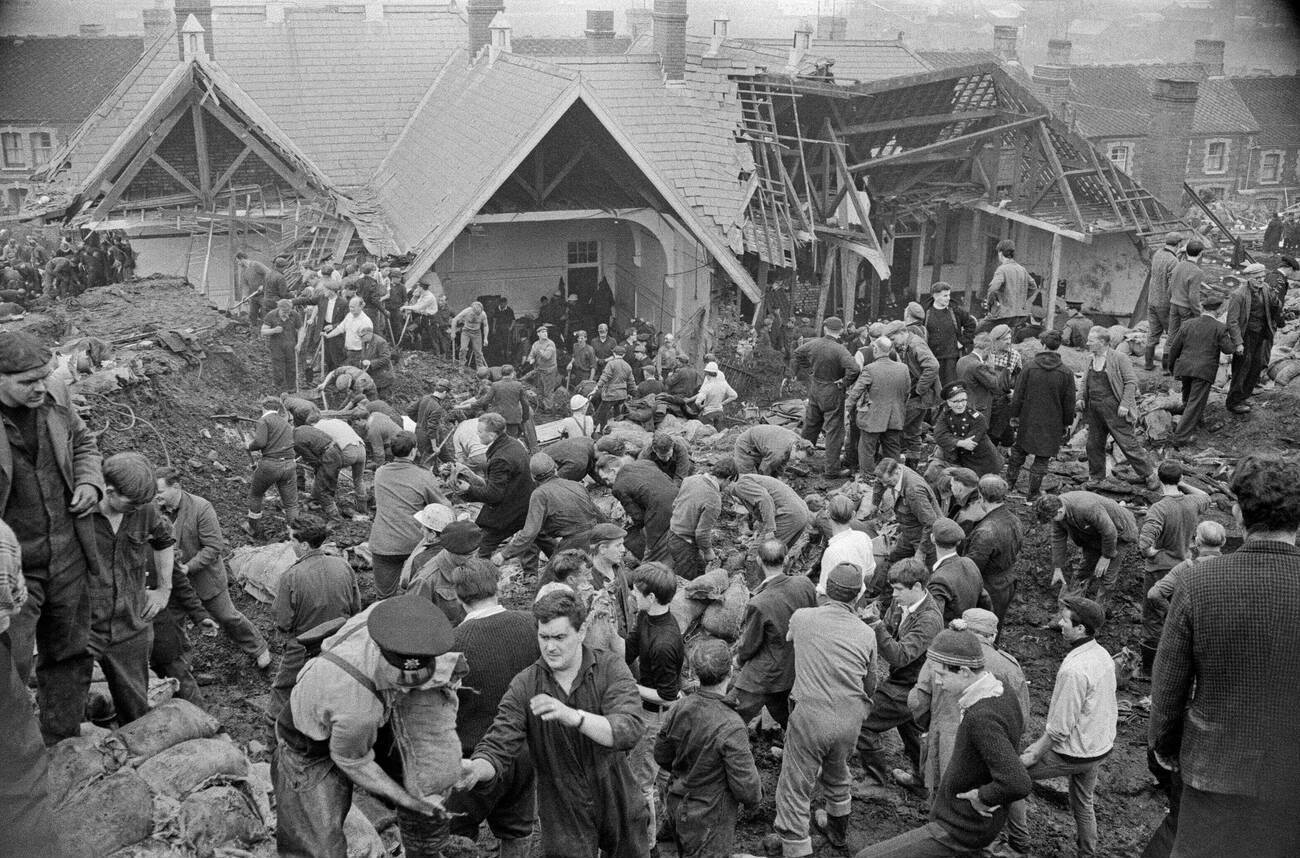 Local men and the emergency services hastily dig through the mud for survivors at the Pantglas Junior School, 1966.