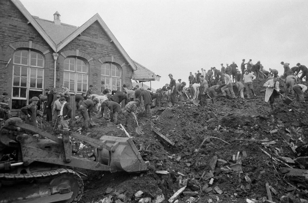 Local men, emergency services all dig for possible signs of life at the Pantglas Junior School, which has collapsed in a catastrophic mud slide, 1966.