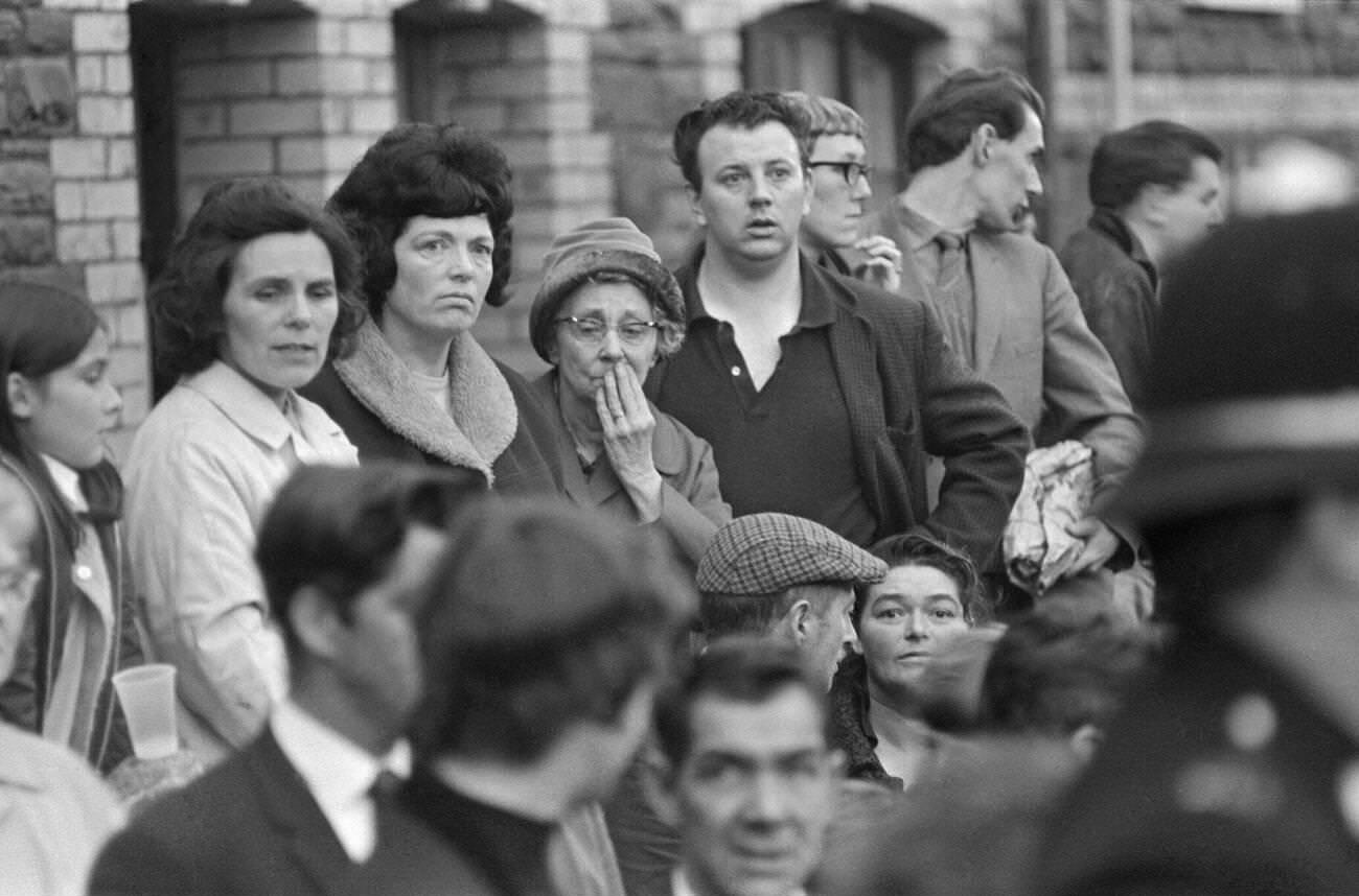 Onlookers in the town of Aberfan look shocked and bewildered as the rescue effort at the Pantglas Junior School continues, 1966.