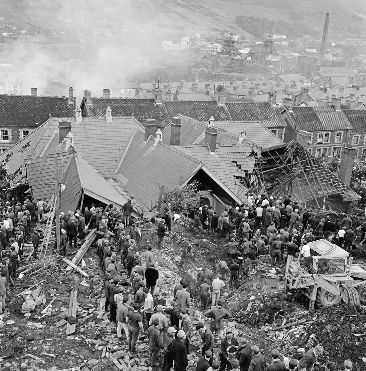 An aerial picture shows the Pantglas Junior School, collapsed under the weight of mud, and the many villagers and emergency services helping to free trapped children and adults, 1966.