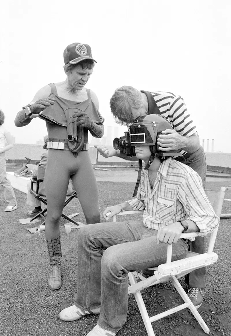 Fred Waugh looks on as crew members make adjustments to the “camera-hat.”