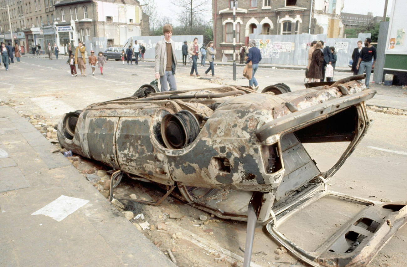 Wrecked buildings and cars in Brixton, London, following the 1981 riots.