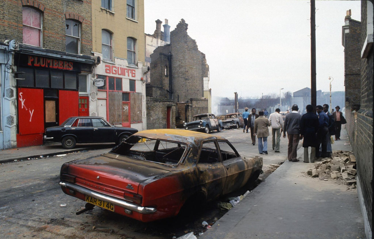 The aftermath of the Brixton Riot, showing damaged cars and buildings that had been set on fire in Brixton, London, 1981. The riot was a series of clashes between mainly black youths and the Metropolitan Police as a result of racist discrimination against the black community.