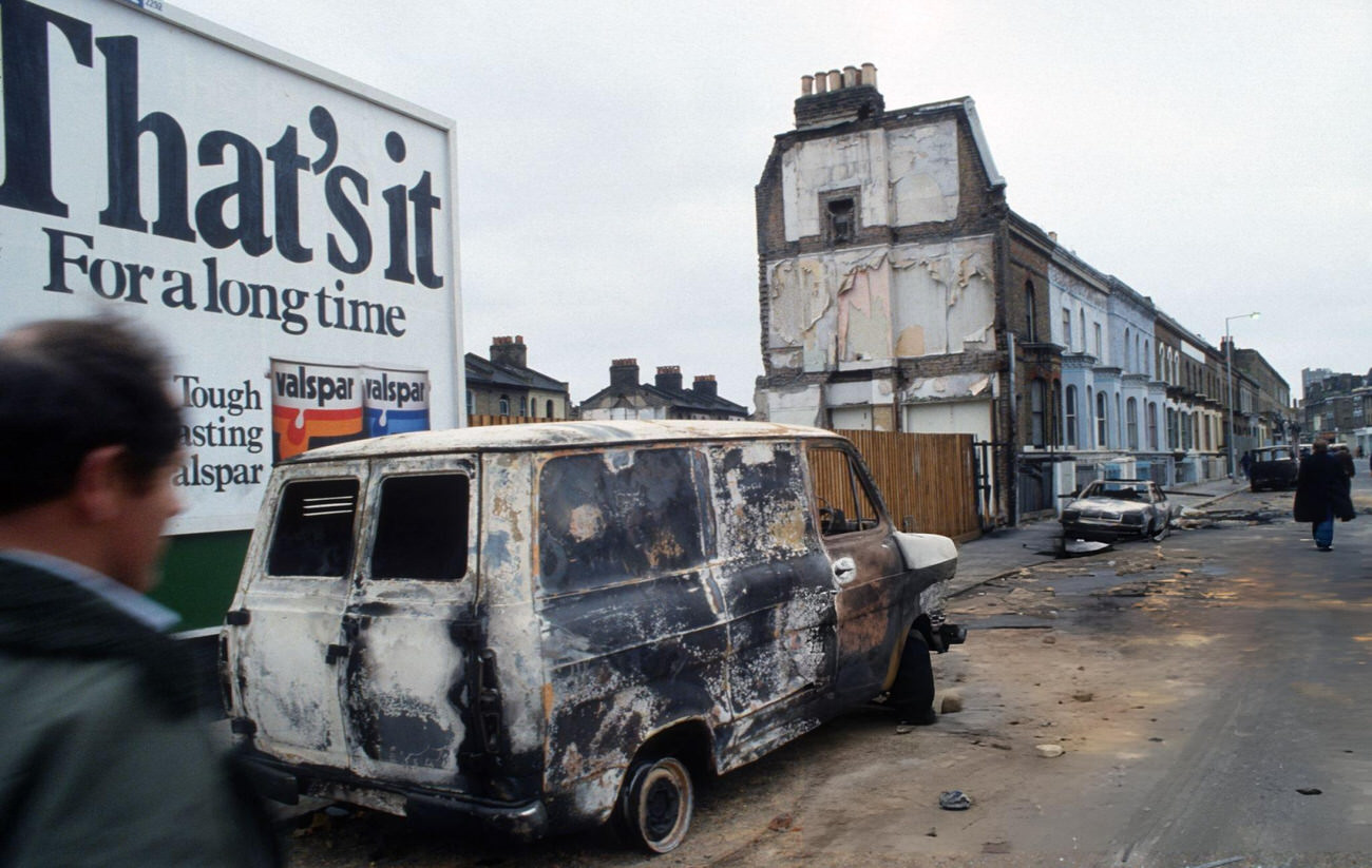 The aftermath of the Brixton Riot, showing damaged cars and buildings that had been set on fire in Brixton, London, 1981.