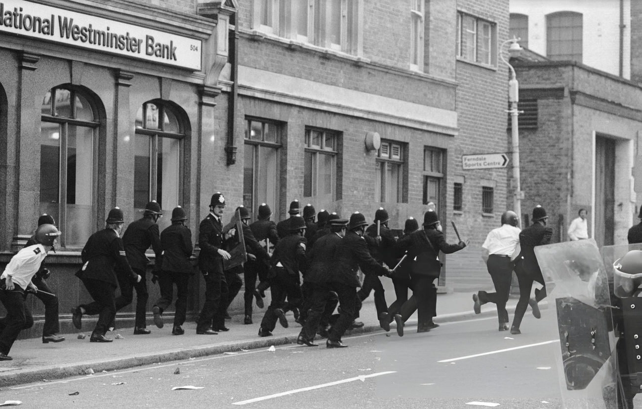 A large group of policemen outside a National Westminster Bank during the Brixton Riot of April 11, 1981.