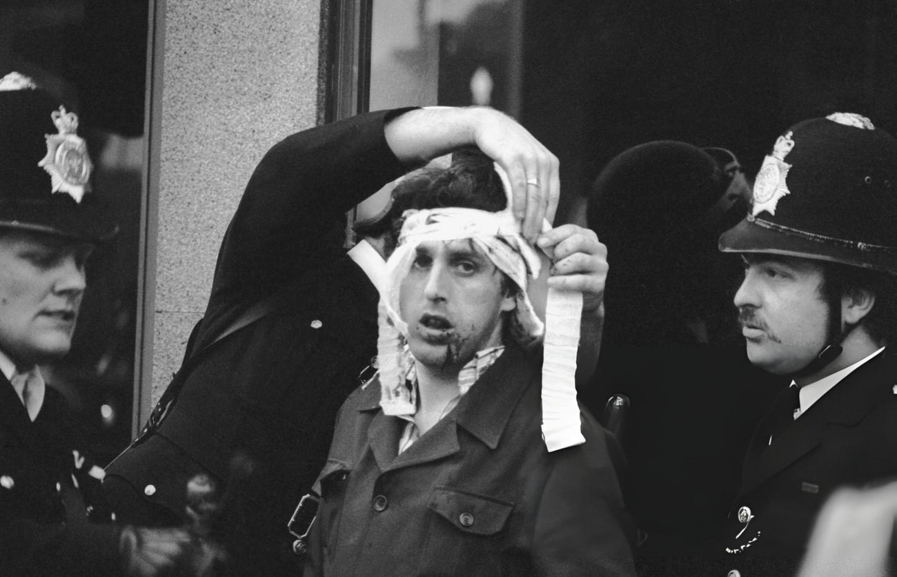 The police help an injured man during the Brixton Riot of April 11, 1981.